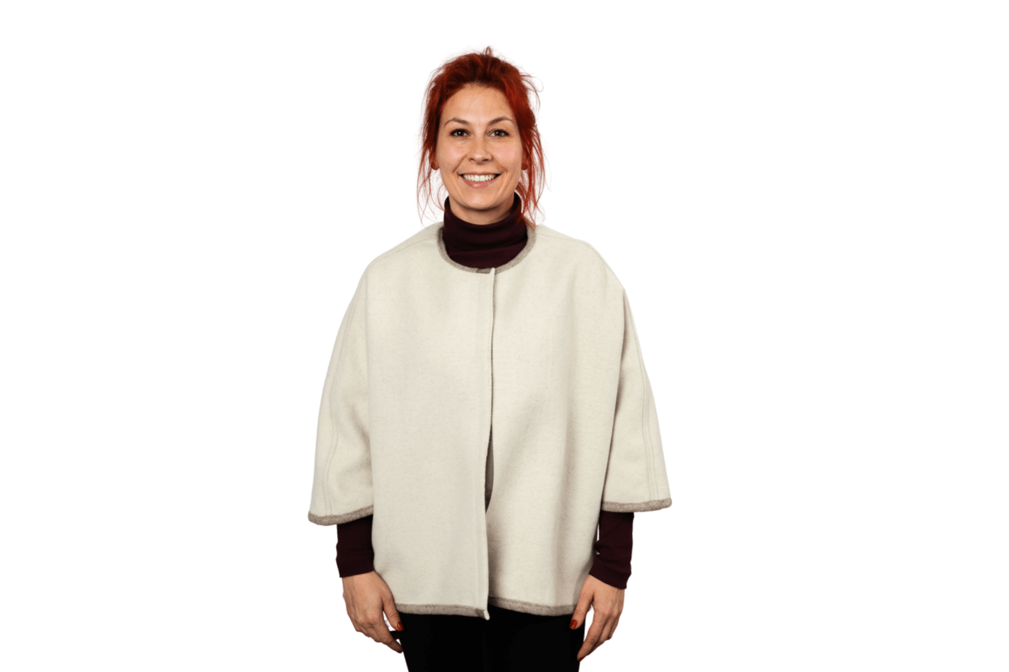 Model prĂ€sentiert das Wendecape Gretchen Couture von Greta & PAUL in Beige-WollweiĂ, Frontansicht der gewendeten wollweiĂen Seite.