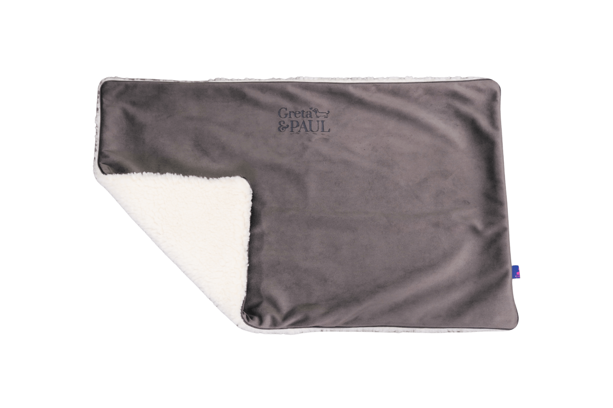 Premium-Hundedecke von Greta & PAUL in Anthrazit, die umgeschlagene Ecke zeigt das kuschelige, weiße Teddyfutter.
