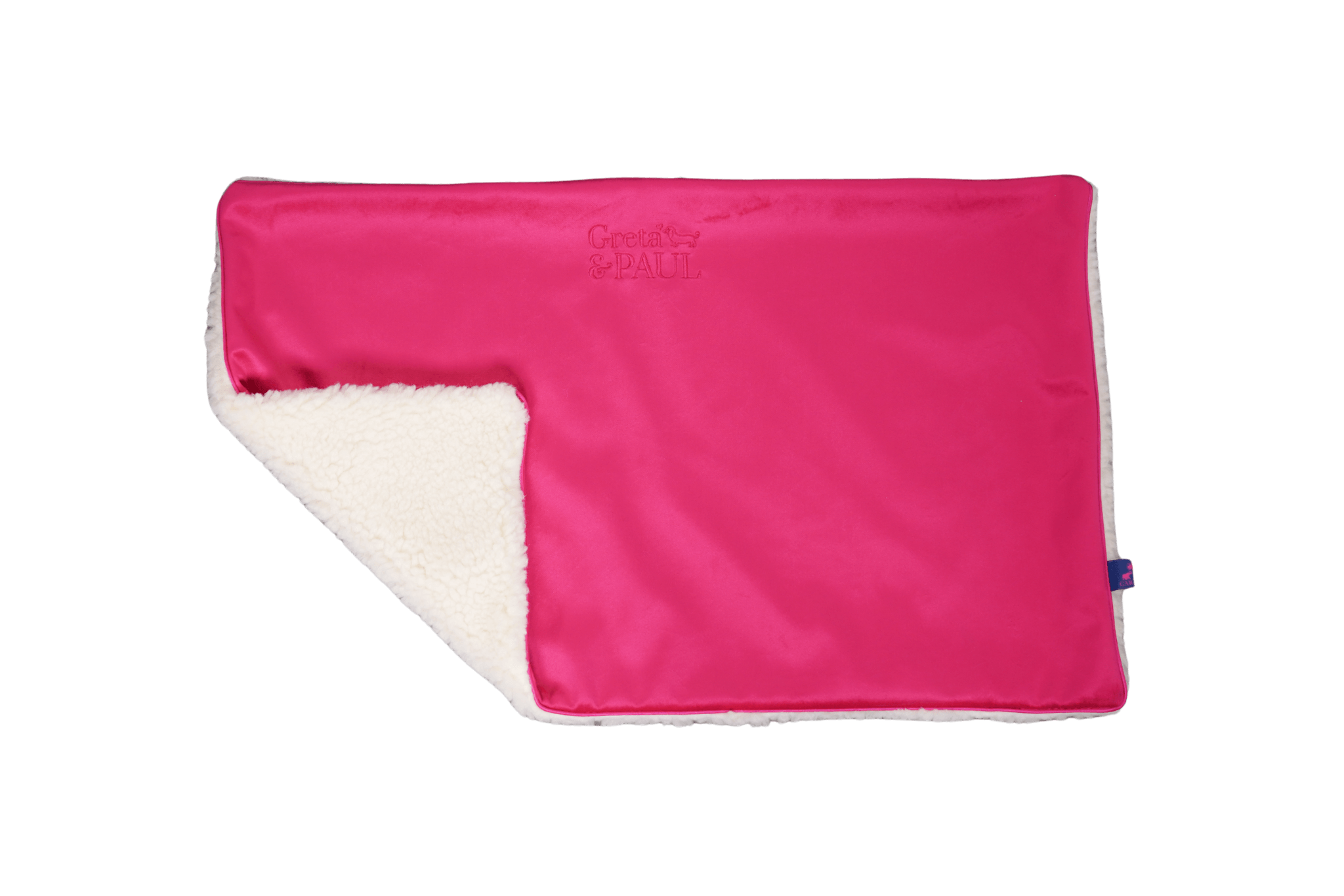 Premium-Hundedecke von Greta & PAUL in Pink, die umgeschlagene Ecke zeigt das kuschelige, weiße Teddyfutter.
