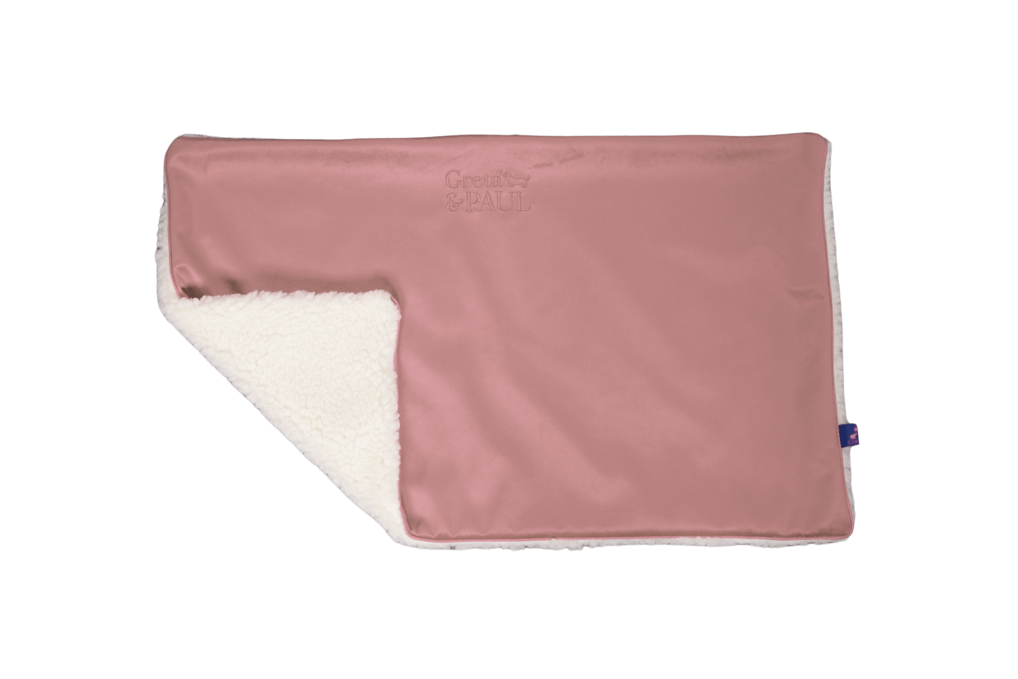 Premium-Hundedecke von Greta & PAUL in Rosa, die umgeschlagene Ecke zeigt das kuschelige, weiße Teddyfutter.
